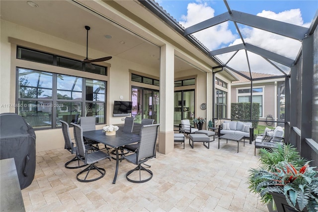 sunroom / solarium featuring ceiling fan