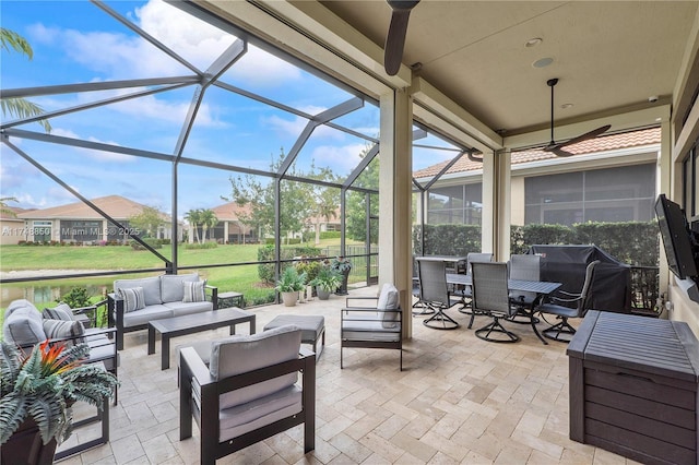 view of patio with outdoor dining area, glass enclosure, and an outdoor living space