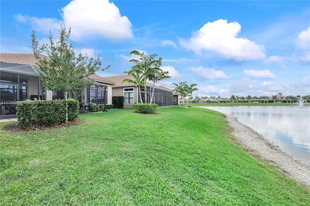 view of yard featuring a water view and a lanai