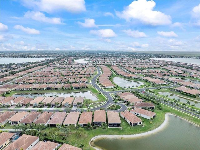birds eye view of property with a water view and a residential view