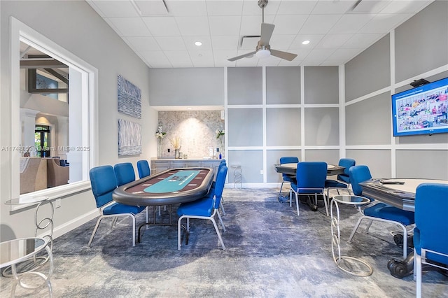 interior space featuring a ceiling fan, recessed lighting, a drop ceiling, and baseboards