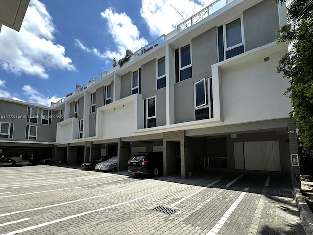 view of property featuring uncovered parking and a residential view