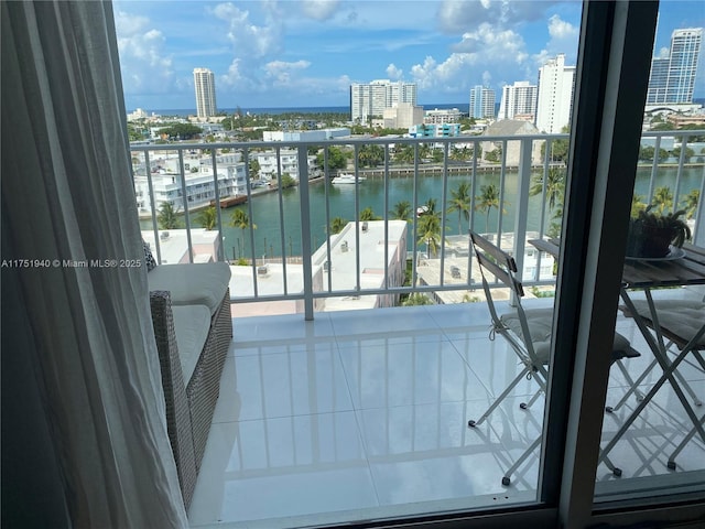 balcony with a view of city and a water view