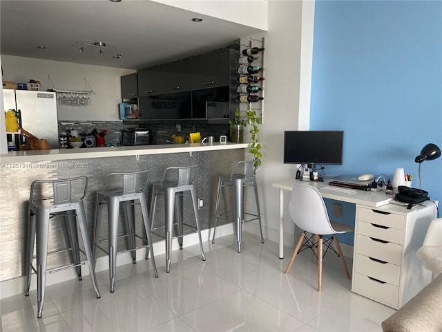 interior space featuring tile patterned flooring and a toaster