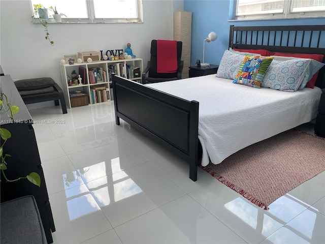 tiled bedroom featuring multiple windows