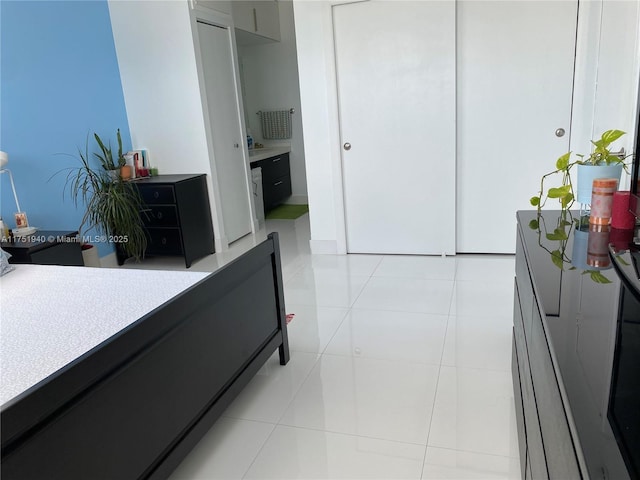 bedroom with light tile patterned floors