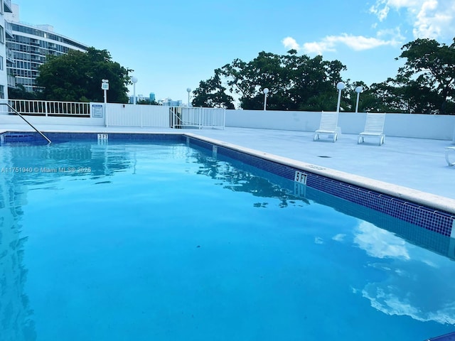 community pool featuring fence