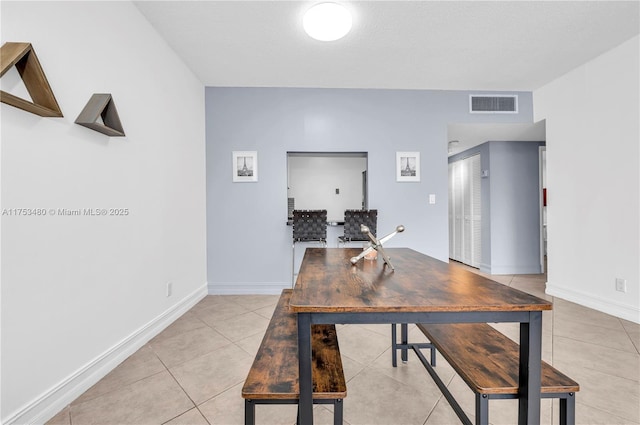 dining area with light tile patterned floors, visible vents, and baseboards