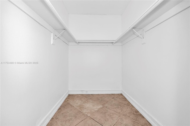 spacious closet featuring light tile patterned floors