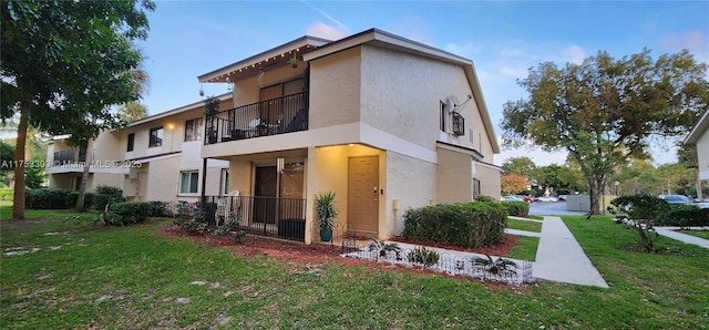 exterior space featuring a lawn and stucco siding