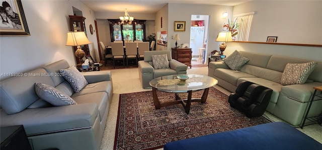 living area featuring carpet and a notable chandelier