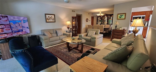 111 Gardens Dr Unit 203, Pompano Beach, FL 33069 - living room featuring a chandelier and carpet flooring