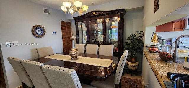 dining room featuring visible vents and an inviting chandelier