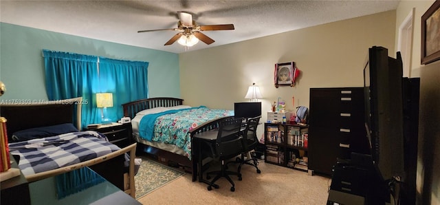 carpeted bedroom featuring a ceiling fan and a textured ceiling