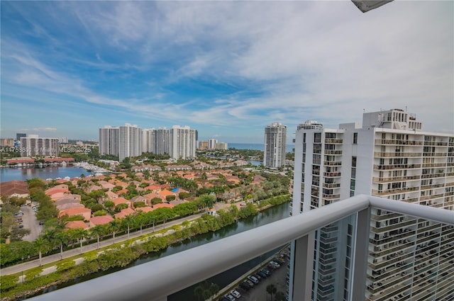 balcony featuring a water view and a city view