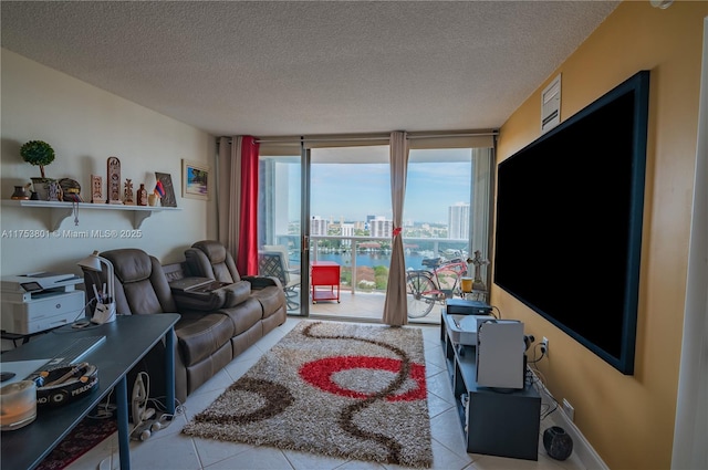 living area with a textured ceiling, floor to ceiling windows, baseboards, and tile patterned floors