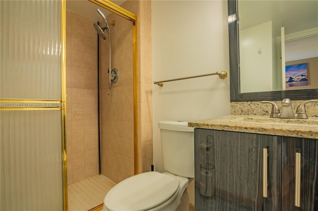 full bath featuring a stall shower, vanity, and toilet