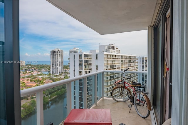 balcony featuring a water view and a view of city