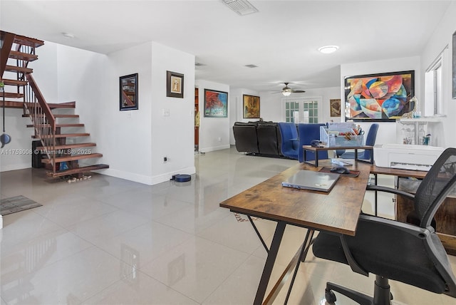 tiled office space featuring baseboards, visible vents, and ceiling fan