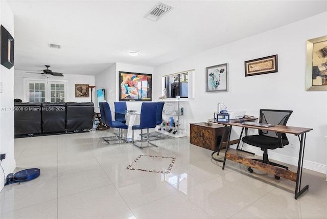 tiled office space featuring baseboards, visible vents, and a ceiling fan