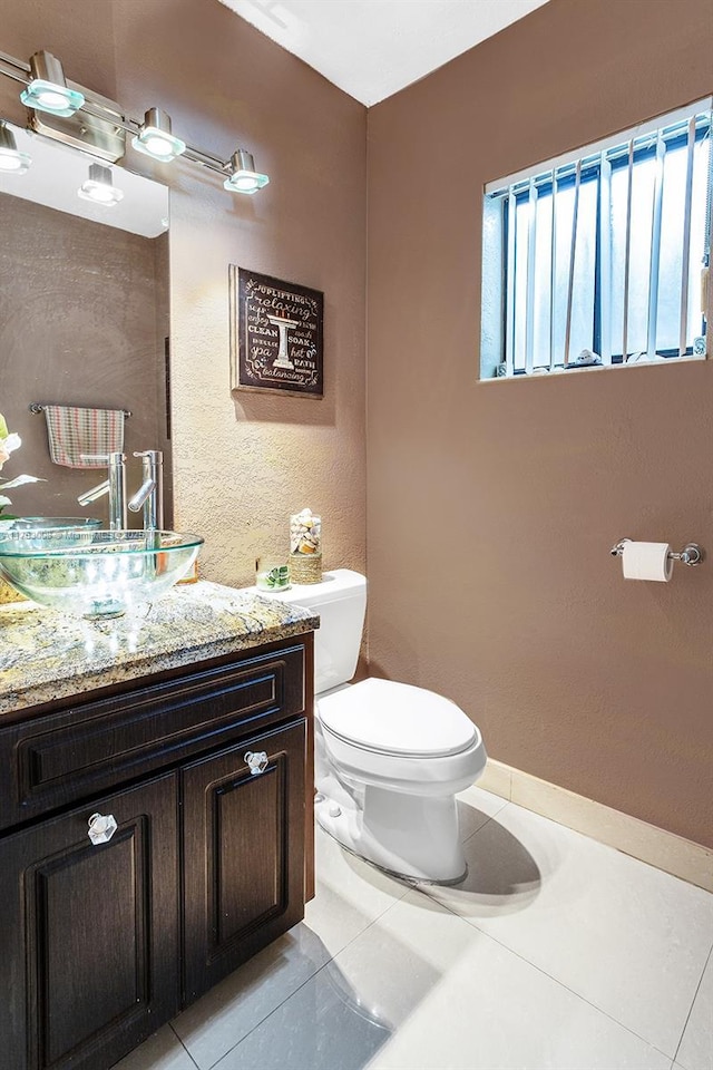 bathroom featuring vanity, toilet, and tile patterned floors