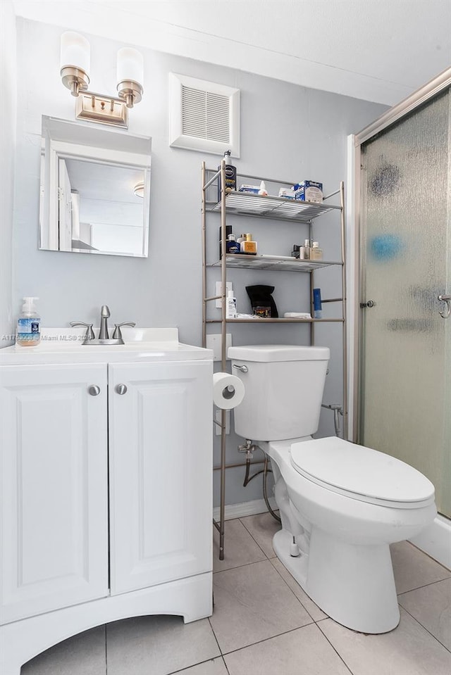 full bathroom featuring toilet, a shower stall, vanity, and tile patterned floors