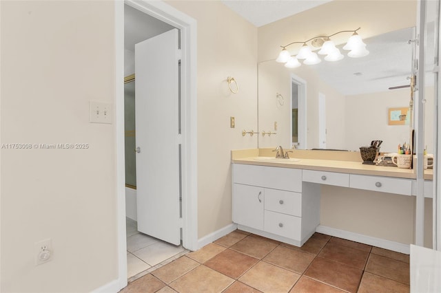 bathroom featuring tile patterned flooring, vanity, and baseboards