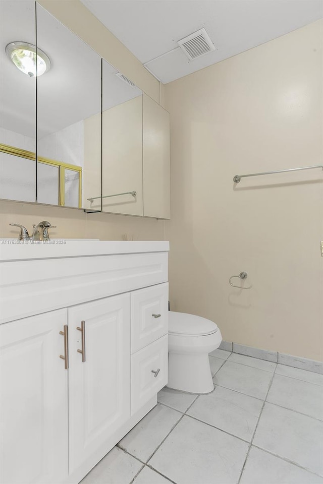 bathroom featuring toilet, a shower with shower door, vanity, visible vents, and tile patterned floors