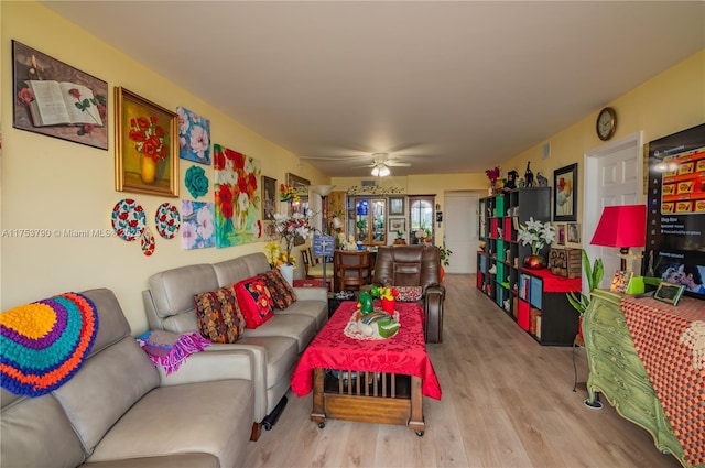 living room featuring ceiling fan and wood finished floors