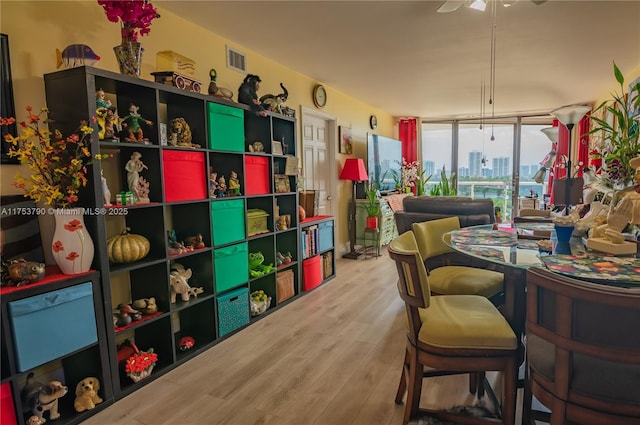 playroom featuring floor to ceiling windows, visible vents, and wood finished floors