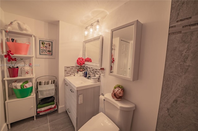 bathroom featuring toilet, decorative backsplash, vanity, and tile patterned floors