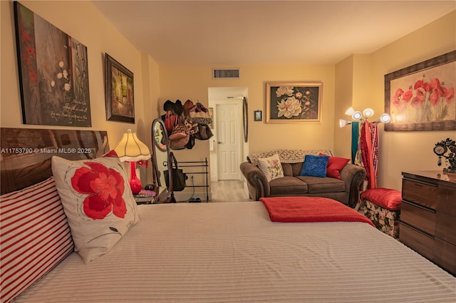 bedroom with wood finished floors and visible vents