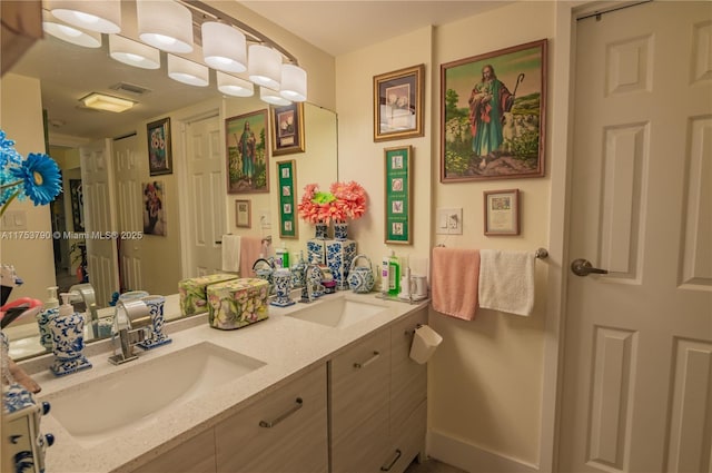 full bath with double vanity, visible vents, and a sink