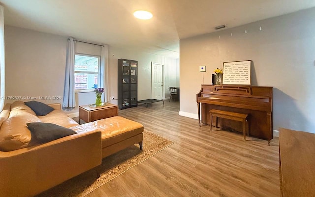 interior space with visible vents, baseboards, and wood finished floors