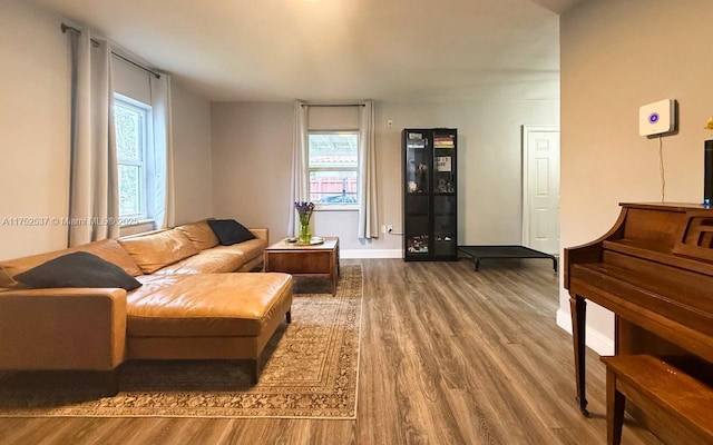 living room featuring wood finished floors and baseboards