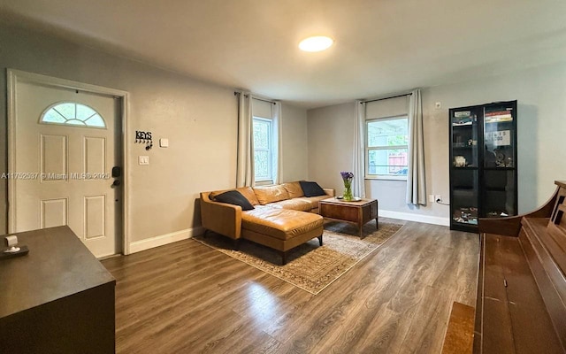 living area with dark wood-style floors and baseboards