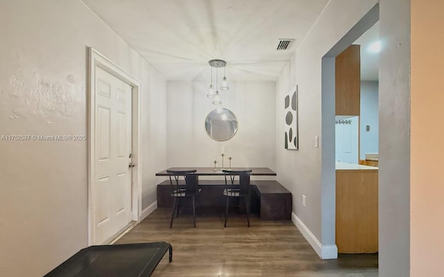 dining room featuring visible vents, baseboards, and wood finished floors