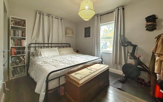 bedroom featuring wood finished floors and baseboards