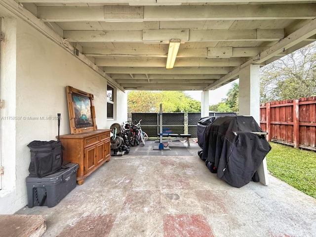 view of patio / terrace with an attached carport, grilling area, and a fenced backyard