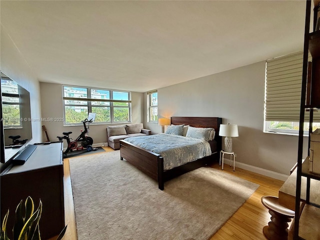 bedroom featuring baseboards and wood finished floors