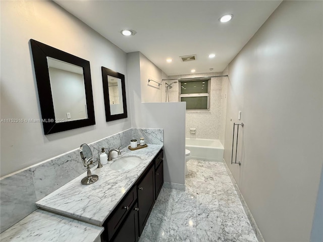 bathroom featuring toilet, vanity, visible vents, marble finish floor, and washtub / shower combination