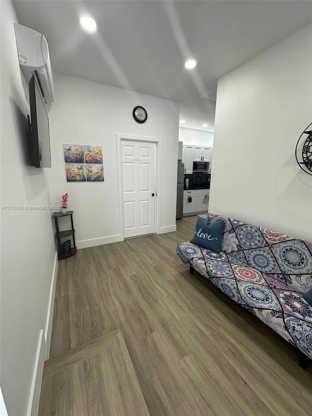 unfurnished living room with light wood-style floors, recessed lighting, and baseboards