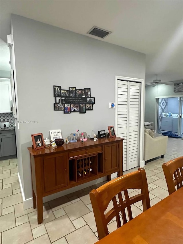 dining area featuring ceiling fan, visible vents, and light tile patterned flooring