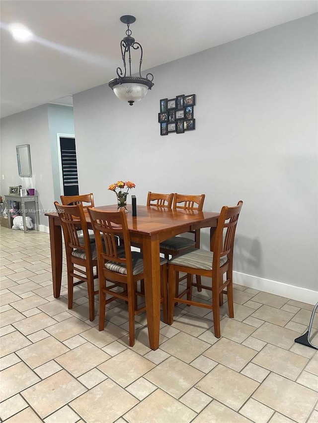 dining area featuring baseboards and light tile patterned floors