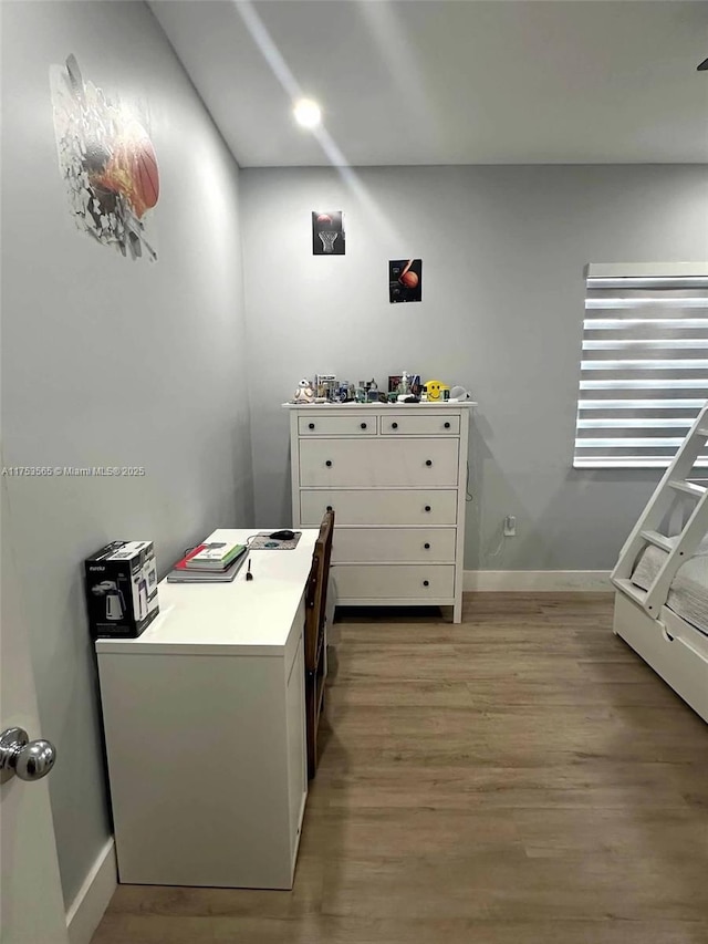 home office featuring light wood-style flooring and baseboards