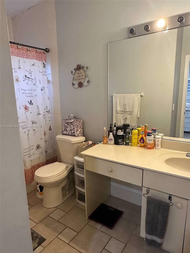 bathroom with curtained shower, vanity, toilet, and tile patterned floors