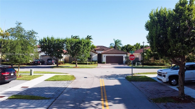 15340 SW 176th Ln, Miami, FL 33187 - view of asphalt street featuring sidewalks, traffic signs, and street lighting