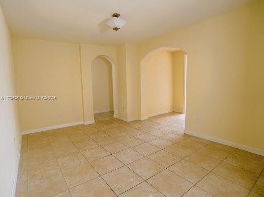 15340 SW 176th Ln, Miami, FL 33187 - unfurnished room with arched walkways and light tile patterned floors