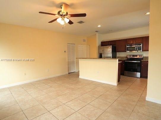 15340 SW 176th Ln, Miami, FL 33187 - kitchen featuring appliances with stainless steel finishes, open floor plan, a ceiling fan, light tile patterned floors, and recessed lighting