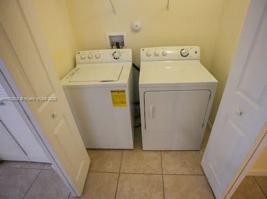 15340 SW 176th Ln, Miami, FL 33187 - laundry room with independent washer and dryer and light tile patterned floors